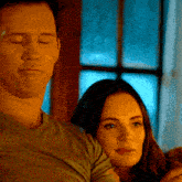 a man and a woman are standing next to each other