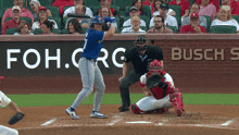 a baseball player is swinging at a pitch in front of a busch sign