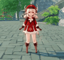 a girl in a red outfit is standing on a brick sidewalk with a backpack .