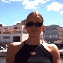 a woman wearing sunglasses and a black shirt with a dickies logo on it