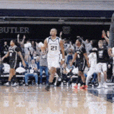a basketball player with the number 21 on his shirt
