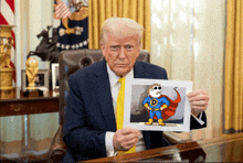 a man in a suit and tie is holding a picture of a cartoon character