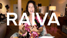 a woman sitting in a chair with the word raiva written in white
