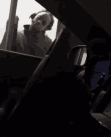 a person in a storm trooper helmet is looking out the window of a car
