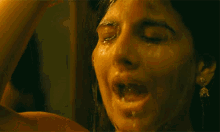 a close up of a woman 's face with water coming out of her mouth .