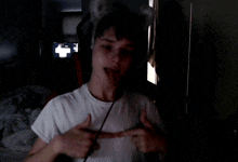 a young boy wearing a cat ear headband is making a funny face with his tongue out