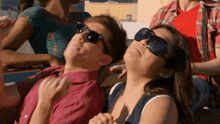 a group of people wearing sunglasses are looking up