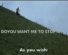 a man is riding a bike down a grassy hill with the words `` do you want me to stop ? '' as you wish .