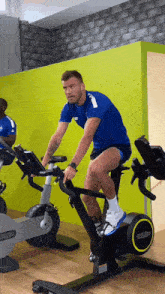 a man riding an exercise bike in a gym