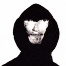 a black and white photo of a man wearing a hooded jacket with his face visible .
