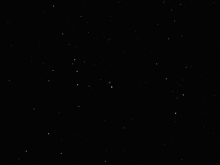a black circle is surrounded by triangles and stars