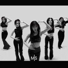 a black and white photo of a group of women dancing with the letters ms on the bottom right
