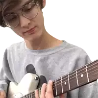 a young man with glasses is playing a guitar