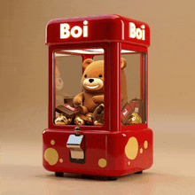 a red boi claw machine with a teddy bear inside