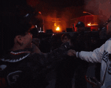 a man wearing a new york yankees hat talks to another man
