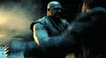 a bald man is shaking hands with another bald man