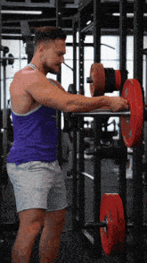 a man wearing a purple tank top that says " fly the "