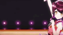 a girl with purple hair is singing into a microphone on a stage