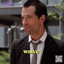 a man in a suit and tie says " what " in yellow letters