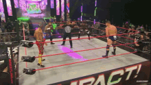 a group of wrestlers are in a ring that says impact