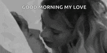 a woman is kissing another woman in a black and white photo and says `` good morning my love '' .