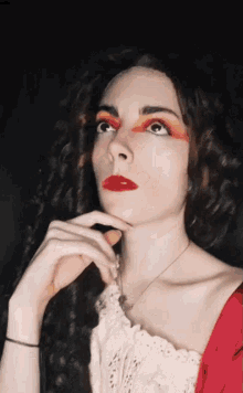 a woman with red lipstick on her lips and red eyeshadow