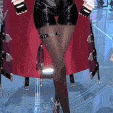 a woman wearing a red cape and black shorts has a belt around her waist
