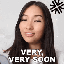 a woman says " very very soon " while looking at herself in a mirror