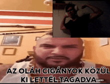 a man with a beard is wearing headphones and has the words az olah ciganyok kozul ki lettel tagadva