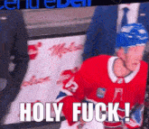 a hockey player says holy fuck in front of a banner that says center