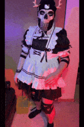 a person dressed in a maid costume with a hello kitty hat