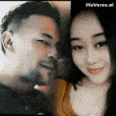 a man and a woman are standing next to each other and smiling .