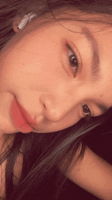 a close up of a woman 's face with a slight smile on her face