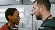 a man and a woman are standing next to each other in a hospital room and the man is saying wait two minutes for the stat .