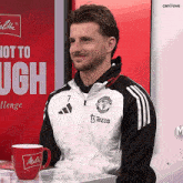 a man wearing a jacket that says manchester united