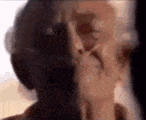 a close up of a person 's face with a blurred background