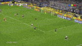 a soccer game is being played in front of a quinni advertisement