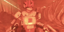 a man in a space suit is holding a gun in a video game