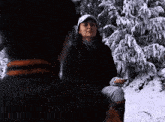 a man and a woman are sitting in the snow .