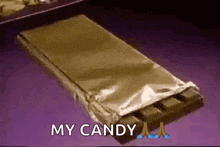 a bar of chocolate is wrapped in foil and says " my candy "