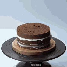 a mr.cakes cake sitting on top of a black cake stand