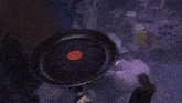 a person in a blue shirt is standing on a pan