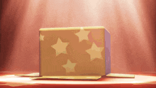 a cube with stars on it is sitting on a stage