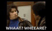 a man in a leather jacket is talking to another man .