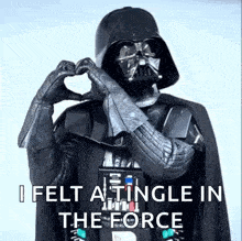 darth vader is making a heart shape with his hands in the force .