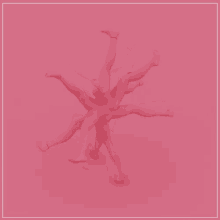 a group of pink mannequins are standing on a pink background .