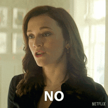a woman says no in front of a netflix ad
