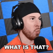 a man wearing headphones and a headband is asking what is that .