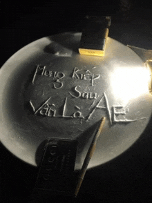 a gucci card sits next to a lighter and a plate with writing on it