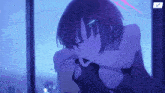 a girl is sitting in front of a window with her eyes closed and a purple light behind her .
